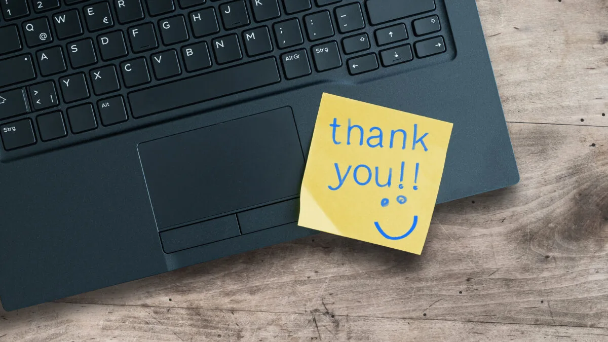 Thank you sticky note on laptop Adobe Stock 273889085