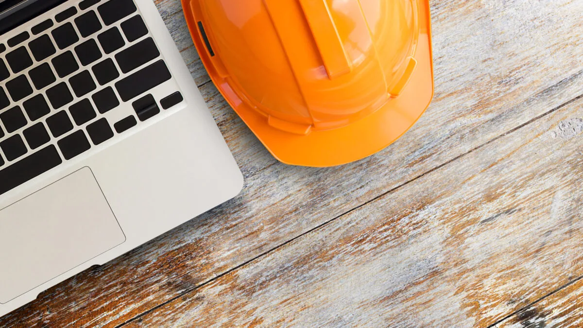 Hard Hat Computer on Table Adobe Stock 485259878
