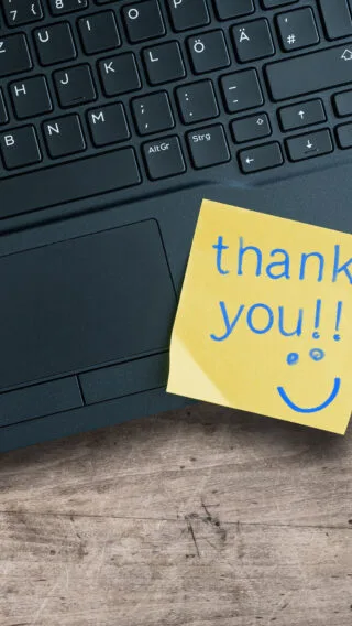 Thank you sticky note on laptop Adobe Stock 273889085